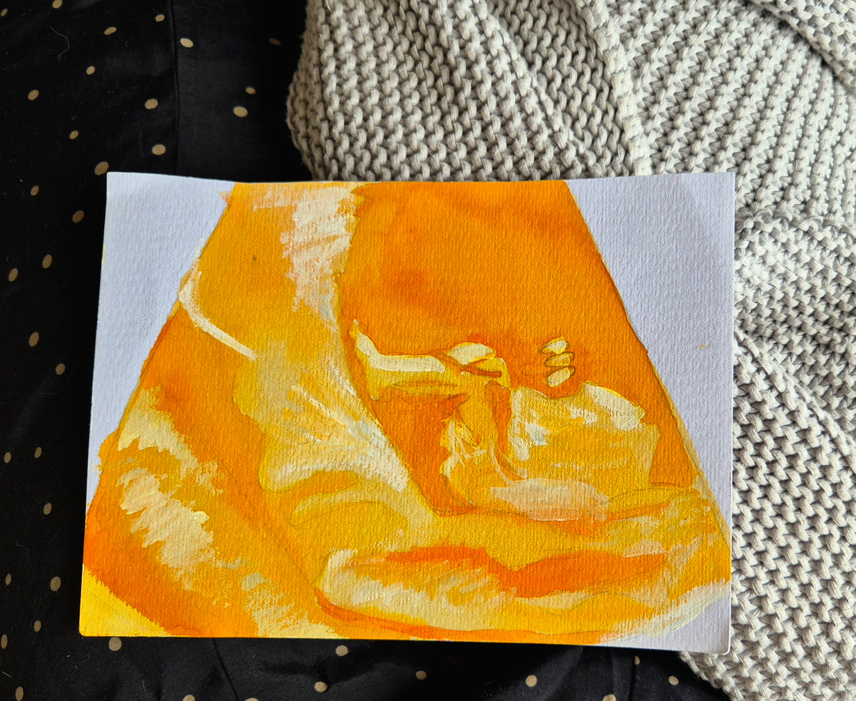 Small painting of a fetus in orange and white 