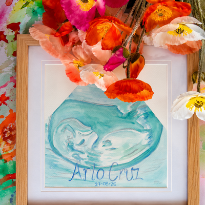 Framed artwork with a blue green ultrasound  and babies name and birthday, surrounded by colorful flowers.