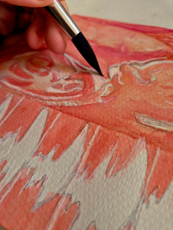 close up shot of paintbrush on paper painting pink ultrasound watercolour