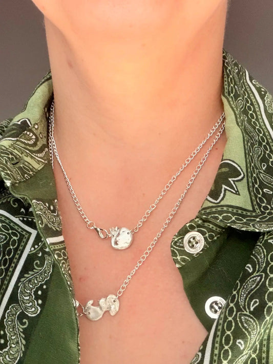 hand made silver ultrasound pendants on chain around womans neck
